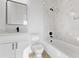 Modern bathroom featuring marble-style tile surround and sleek black fixtures at 104 Alta Vista Way, Davenport, FL 33837