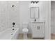 Stylish bathroom includes a shower-tub, marble-style tile, and elegant black hardware at 104 Alta Vista Way, Davenport, FL 33837