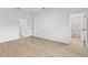 This bedroom features wood-look floors and is bright and airy with two doorways at 104 Alta Vista Way, Davenport, FL 33837