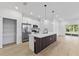Spacious kitchen featuring an island, stainless steel appliances, and ample pantry storage at 104 Alta Vista Way, Davenport, FL 33837