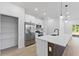 Clean kitchen with large island, stainless steel appliances, and pantry storage at 104 Alta Vista Way, Davenport, FL 33837