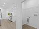 Bright laundry room features wood-look floors and sleek, modern washer/dryer hookups at 104 Alta Vista Way, Davenport, FL 33837