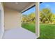 Covered patio with a view of the expansive backyard and lush green landscape at 104 Alta Vista Way, Davenport, FL 33837
