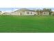 Expansive backyard featuring a green lawn and neighboring houses in the distance at 108 Alta Vista Way, Davenport, FL 33837