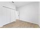 Bright bedroom features a closet with double doors, a window, and new flooring at 108 Alta Vista Way, Davenport, FL 33837