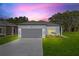 Charming single-story home featuring a two-car garage, grey exterior paint, and a well-manicured front lawn at 108 Alta Vista Way, Davenport, FL 33837
