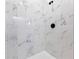 Close up of the walk-in shower featuring white marble-look tiling and black hardware at 108 Alta Vista Way, Davenport, FL 33837