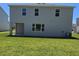 Expansive backyard with lush lawn, featuring a covered patio, perfect for outdoor enjoyment at 1169 Happy Forest Loop, Deland, FL 32720