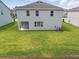Backyard view highlighting the well-maintained lawn and the home's exterior at 1169 Happy Forest Loop, Deland, FL 32720