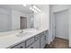 Modern bathroom featuring a double sink vanity, large mirror, and stylish wood-look flooring at 1169 Happy Forest Loop, Deland, FL 32720