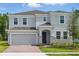 Charming two-story home with gray siding, stone accents, and manicured front yard at 1169 Happy Forest Loop, Deland, FL 32720