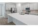 Modern kitchen featuring white cabinets, stainless steel appliances, and a spacious island at 1169 Happy Forest Loop, Deland, FL 32720