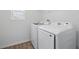 Bright laundry room featuring modern, white Samsung washer and dryer appliances at 1169 Happy Forest Loop, Deland, FL 32720
