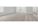 Large, empty living room with light carpeting and plenty of natural light from dual windows at 1169 Happy Forest Loop, Deland, FL 32720