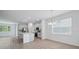 Open-concept kitchen and dining area with tile flooring and lots of natural light at 1169 Happy Forest Loop, Deland, FL 32720