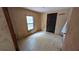 Bedroom featuring a window, a door, and patterned wallpaper at 1275 Arapaho Trl, Geneva, FL 32732