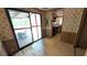 Dining room featuring a sliding glass door, paneled walls, and access to the kitchen at 1275 Arapaho Trl, Geneva, FL 32732
