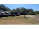 View of home with a covered porch, surrounded by trees and a large grassy yard at 1275 Arapaho Trl, Geneva, FL 32732