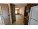 Kitchen with wooden cabinets, a refrigerator, and pass-through to the living area at 1275 Arapaho Trl, Geneva, FL 32732
