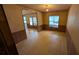 Living room featuring paneled walls, a window, and an open doorway at 1275 Arapaho Trl, Geneva, FL 32732