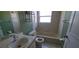 Bathroom featuring a vanity, toilet, tiled tub with tiled walls, and medicine cabinet mirror at 129 Valentino Ct, Davenport, FL 33837