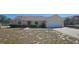 Charming one-story home featuring a well-manicured front yard and an attached two-car garage at 129 Valentino Ct, Davenport, FL 33837