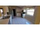 Bright kitchen with white cabinetry, stainless steel appliances, and a window overlooking the yard at 129 Valentino Ct, Davenport, FL 33837