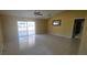Bright living room with tile floors, sliding glass doors, and a decorative mirror at 129 Valentino Ct, Davenport, FL 33837