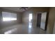 Bright main bedroom with tile floors, ceiling fan, large window, and an ensuite bathroom at 129 Valentino Ct, Davenport, FL 33837