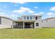 Backyard view of the screened-in patio and well-maintained lawn at 13242 Orange Isle Dr, Windermere, FL 34786