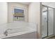 Bright bathroom showcasing a tub, shower and window at 13242 Orange Isle Dr, Windermere, FL 34786