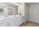 Bright bathroom featuring a double vanity, white cabinets, and modern finishes at 13242 Orange Isle Dr, Windermere, FL 34786