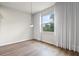 Well-lit bedroom with large window, hardwood floors, and modern light fixture at 13242 Orange Isle Dr, Windermere, FL 34786