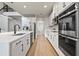 Open kitchen featuring stainless steel appliances, white cabinets, and a spacious layout at 13242 Orange Isle Dr, Windermere, FL 34786