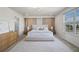 Comfortable bedroom featuring a plush bed, large window, and neutral decor at 13242 Orange Isle Dr, Windermere, FL 34786