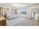 Spacious bedroom with a large bed, soft carpet, and a bright window overlooking the neighborhood at 13242 Orange Isle Dr, Windermere, FL 34786