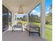 Covered patio with comfortable seating and a view of the green lawn at 13242 Orange Isle Dr, Windermere, FL 34786