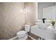 Chic powder room with patterned wallpaper and a modern vessel sink at 13242 Orange Isle Dr, Windermere, FL 34786