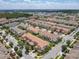 A wide aerial view displays the property's neighborhood featuring other houses, trees, streets and nearby amenities at 14014 Millington St, Orlando, FL 32832