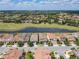 An aerial view shows the property's location, nearby golf course and pond, along with the surrounding community at 14014 Millington St, Orlando, FL 32832