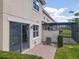 The rear of the property features a brick paver patio area with a sliding door and an adjacent screened in enclosure at 14014 Millington St, Orlando, FL 32832