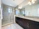 Elegant bathroom showcasing a glass-enclosed shower and double vanity at 14014 Millington St, Orlando, FL 32832