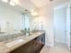 Bathroom boasts double vanity with granite countertops and decorative mirrors at 14014 Millington St, Orlando, FL 32832