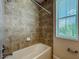 Bathroom shower with decorative tile and window, providing a luxurious and bright space at 14014 Millington St, Orlando, FL 32832