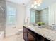 Bathroom featuring a vanity, shower with window, and tile flooring for a bright and clean space at 14014 Millington St, Orlando, FL 32832