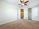 This is a cozy bedroom with a ceiling fan, carpet, and closet at 14014 Millington St, Orlando, FL 32832