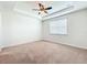 Bright bedroom featuring a tray ceiling, ceiling fan, window, neutral walls, and carpeted flooring at 14014 Millington St, Orlando, FL 32832