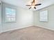 Bedroom featuring a ceiling fan, windows, neutral walls, and carpeted flooring at 14014 Millington St, Orlando, FL 32832