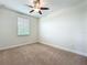 Bedroom featuring a ceiling fan, window, neutral walls, and carpeted flooring at 14014 Millington St, Orlando, FL 32832