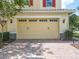 A tan garage door with a brick driveway at 14014 Millington St, Orlando, FL 32832